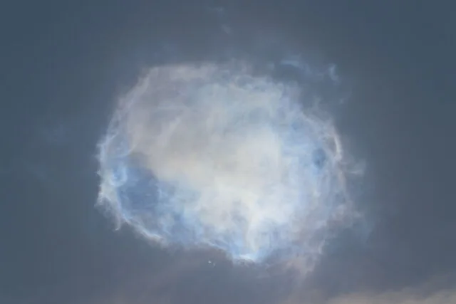 A cloud of propellant and debris lingers high in the sky over South Texas after the explosion of the Super Heavy booster.